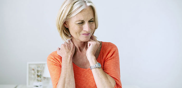 Mature woman suffering from neck and shoulder pain before visiting Brentwood chiropractor