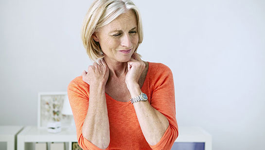 Mature woman suffering from neck and shoulder pain before visiting Brentwood chiropractor