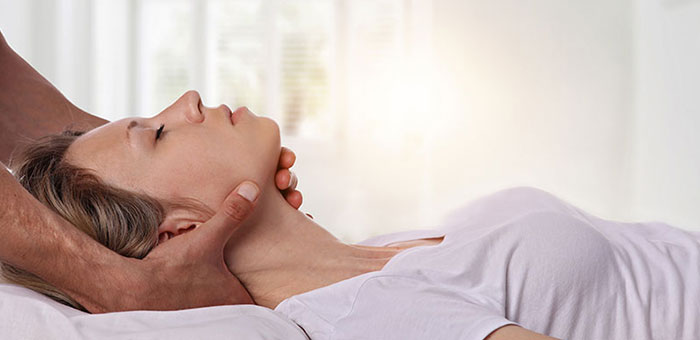 Woman receiving neck adjustment from Brentwood chiropractor