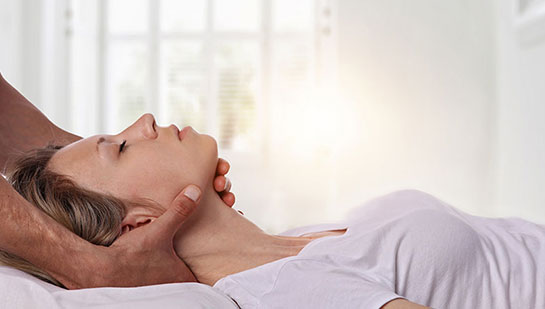 Woman receiving neck adjustment from Brentwood chiropractor