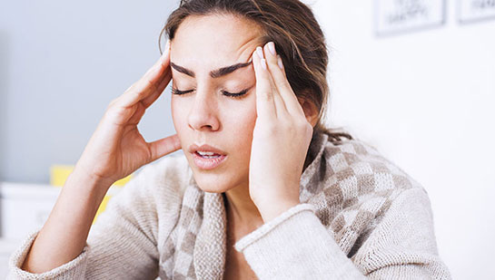 Woman suffering from headache before visiting Brentwood chiropractor