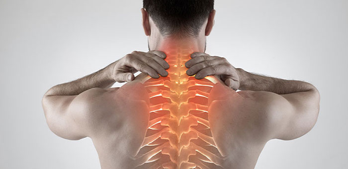 Man with upper back pain before chiropractic treatment from Brentwood chiropractor