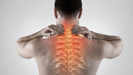 Man with upper back pain before chiropractic treatment from Brentwood chiropractor